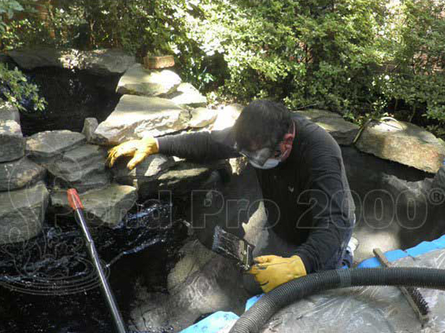 Concrete pond leak repair and sealing work in progress by pondpro2000.com