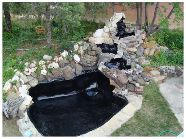 Backyard pond with rock waterfall and waterproof sealed liner by pondpro2000.com